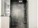 Luxurious bathroom with gray tile shower, shower bench, rain shower head, and glass door at 3473 Beeler St, Denver, CO 80238