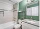 Bathroom with a shower-tub, modern sink and vanity, and green accent walls at 4076 S Carson St # H, Aurora, CO 80014