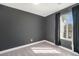 Empty bedroom featuring gray walls, a window, and carpeting at 4076 S Carson St # H, Aurora, CO 80014