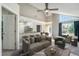 Staged living room features vaulted ceilings, large windows, and open access to the kitchen at 4076 S Carson St # H, Aurora, CO 80014