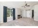 Bright living room with vaulted ceiling, gas fireplace, and large picture window with dark curtains at 4076 S Carson St # H, Aurora, CO 80014