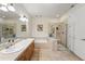 Spacious bathroom featuring double sinks, soaking tub, and glass-enclosed shower at 2100 N Humboldt St # 208, Denver, CO 80205