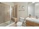 This bathroom features a tiled walk-in shower with glass doors, a toilet, and a sink at 2100 N Humboldt St # 208, Denver, CO 80205