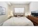 Comfortable bedroom features a tufted headboard, soft bedding, and a modern dresser at 2100 N Humboldt St # 208, Denver, CO 80205