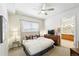 Serene bedroom with a cozy bed, ceiling fan, and access to a bright bathroom for added convenience at 2100 N Humboldt St # 208, Denver, CO 80205