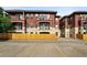 Exterior of building featuring balconies and ample parking spaces for tenants and visitors at 2100 N Humboldt St # 208, Denver, CO 80205