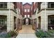 Charming courtyard entrance featuring a gated entrance, stone accents, and beautiful landscaping at 2100 N Humboldt St # 208, Denver, CO 80205