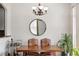 Dining room with a wooden table, patterned chairs, a round mirror, and modern chandelier at 2100 N Humboldt St # 208, Denver, CO 80205