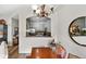 Open dining area with chandelier lighting and pass-through to the kitchen featuring light gray cabinetry and granite countertops at 2100 N Humboldt St # 208, Denver, CO 80205
