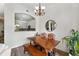 Dining area with wooden table, colorful chairs, and view of the kitchen through serving hatch at 2100 N Humboldt St # 208, Denver, CO 80205
