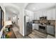 Modern kitchen with stainless steel appliances, granite countertops, mosaic backsplash, and sleek cabinets at 2100 N Humboldt St # 208, Denver, CO 80205