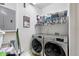 Well-organized laundry room with front-loading washer and dryer and ample shelving for storage at 2100 N Humboldt St # 208, Denver, CO 80205