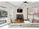 Comfortable living room with corner fireplace, TV, and access to the outdoor balcony at 2100 N Humboldt St # 208, Denver, CO 80205