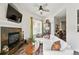 Inviting living room with a fireplace, mounted TV, plush white seating, and stylish decor at 2100 N Humboldt St # 208, Denver, CO 80205