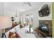 Bright living room with fireplace, seating, and access to the balcony and dining area at 2100 N Humboldt St # 208, Denver, CO 80205
