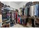 Spacious walk-in closet features hanging clothes, shelves, and ample storage space at 2100 N Humboldt St # 208, Denver, CO 80205