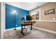 Basement office with standing desk and blue accent wall at 12844 W Cross Dr, Littleton, CO 80127