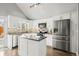 Modern kitchen with white cabinets, stainless steel appliances and island at 12844 W Cross Dr, Littleton, CO 80127