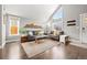 Living room with gray sectional sofa, hardwood floors and mountain art at 12844 W Cross Dr, Littleton, CO 80127