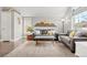 Living room with gray sectional sofa, hardwood floors and mountain art at 12844 W Cross Dr, Littleton, CO 80127