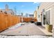 Concrete patio with a wooden fence, providing ample space for outdoor entertaining at 12844 W Cross Dr, Littleton, CO 80127