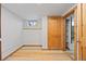 Unfinished basement with wood-look flooring and a window letting in natural light at 5012 W 36Th Ave # 5, Denver, CO 80212