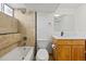 Bathroom featuring tile shower, tub, a wood vanity with storage, toilet and modern fixtures at 5012 W 36Th Ave # 5, Denver, CO 80212
