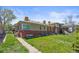 Brick two-story home featuring a well-maintained lawn and sidewalk leading to the front entrance at 5012 W 36Th Ave # 5, Denver, CO 80212