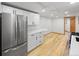 Kitchen featuring stainless steel appliances and white cabinets with wooden floor at 5012 W 36Th Ave # 5, Denver, CO 80212