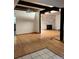 Spacious living room featuring hardwood floors and a stone fireplace at 5063 W Radcliff Ave, Denver, CO 80236
