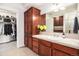 Bathroom featuring wood cabinets and a walk in closet at 1699 N Downing St # 302, Denver, CO 80218