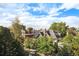 Tree-lined neighborhood with a mix of residential homes under a blue sky at 1699 N Downing St # 302, Denver, CO 80218