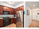Kitchen with granite countertops, stainless steel appliances, and wood cabinets at 1699 N Downing St # 302, Denver, CO 80218