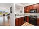 Stylish kitchen featuring granite countertops, stainless steel appliances, and cherry wood cabinets at 1699 N Downing St # 302, Denver, CO 80218