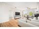 Spacious living room with hardwood floors, a fireplace, a comfortable white sofa, and plenty of natural light at 1699 N Downing St # 302, Denver, CO 80218
