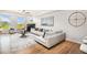 Sun-filled living room features stylish furnishings, hardwood floors, and large windows at 1699 N Downing St # 302, Denver, CO 80218