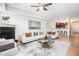 Bright and open living room with hardwood floors, fireplace, white sofa, and an open kitchen at 1699 N Downing St # 302, Denver, CO 80218