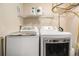 Laundry area with white, front-load washer and dryer, with storage shelf above, and gas piping at 1699 N Downing St # 302, Denver, CO 80218