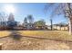 A grassy backyard features a wooden deck and a covered patio attached to the house at 11237 W 59Th Ave, Arvada, CO 80004