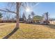 An expansive grassy backyard features a wooden deck and a covered patio at 11237 W 59Th Ave, Arvada, CO 80004