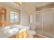 Well-lit bathroom features a large mirror, a single sink, and a shower stall at 11237 W 59Th Ave, Arvada, CO 80004