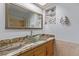 Bathroom featuring a unique glass bowl sink atop a marble countertop and a large mirror at 11237 W 59Th Ave, Arvada, CO 80004