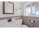 Cozy bathroom with modern vanity, toilet, and fun signage at 11237 W 59Th Ave, Arvada, CO 80004
