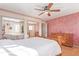 Bedroom featuring hardwood floors, decorative accents, ample natural light, and mirrored closet at 11237 W 59Th Ave, Arvada, CO 80004