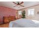 Bedroom features hardwood floors, decorative accents, a plant, and a wooden door at 11237 W 59Th Ave, Arvada, CO 80004
