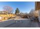 An outdoor deck is arranged with an ornate table and chairs overlooking a backyard at 11237 W 59Th Ave, Arvada, CO 80004