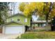 Charming two-story home with a brick and siding exterior, a large front yard, and mature trees at 11237 W 59Th Ave, Arvada, CO 80004