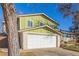 Charming two-story home with a well-maintained lawn and a two-car garage at 11237 W 59Th Ave, Arvada, CO 80004