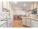 Kitchen featuring an oven, cabinetry, and a view to the living room with a fireplace at 11237 W 59Th Ave, Arvada, CO 80004