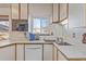 Well-lit kitchen features bright counters, double sink, modern appliances, and window at 11237 W 59Th Ave, Arvada, CO 80004
